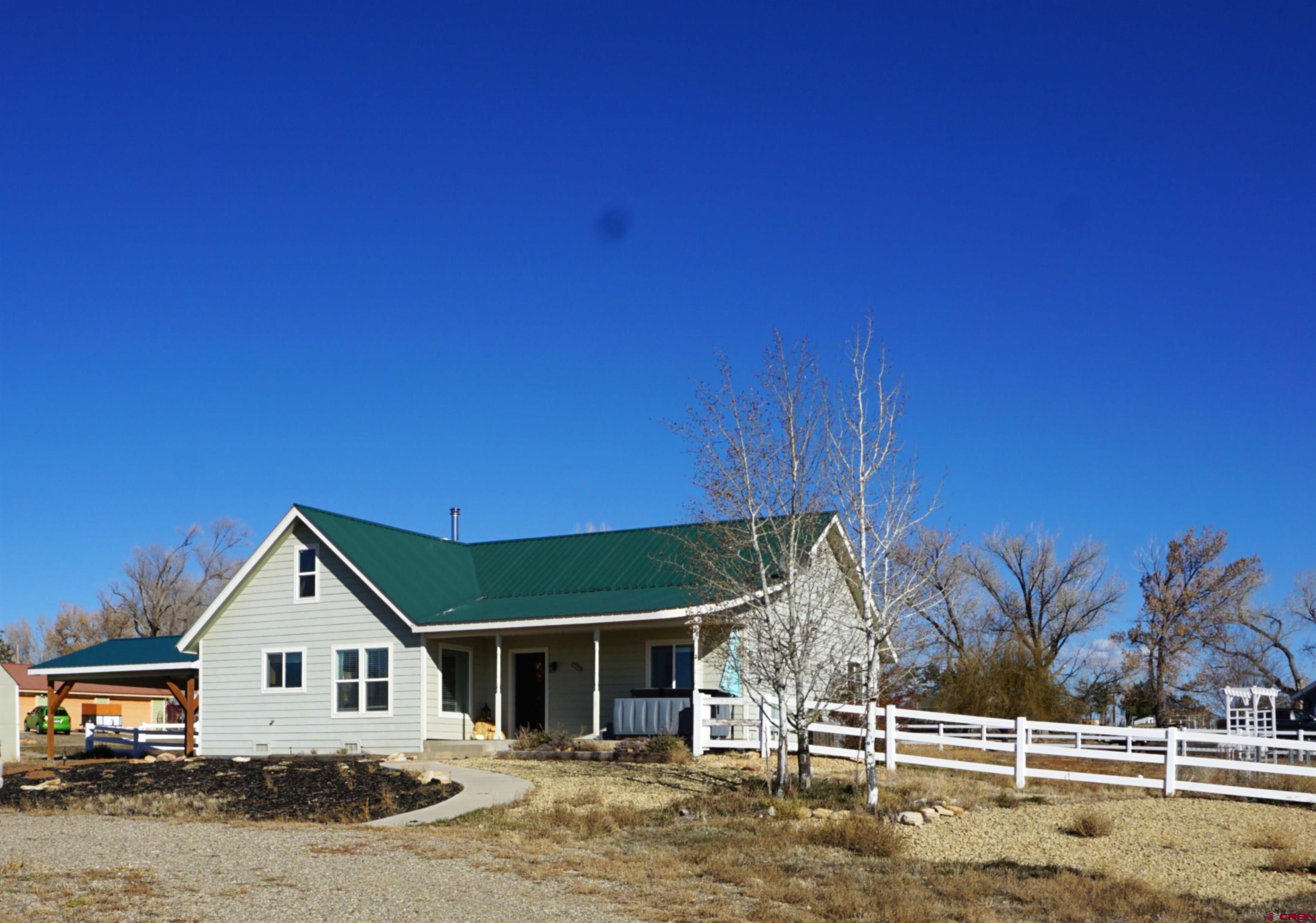 a view of a house with wooden fence