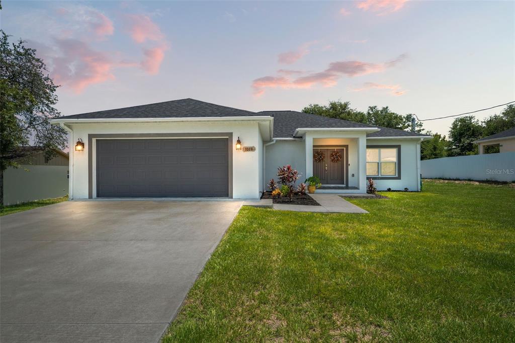 a front view of house with yard and outdoor seating