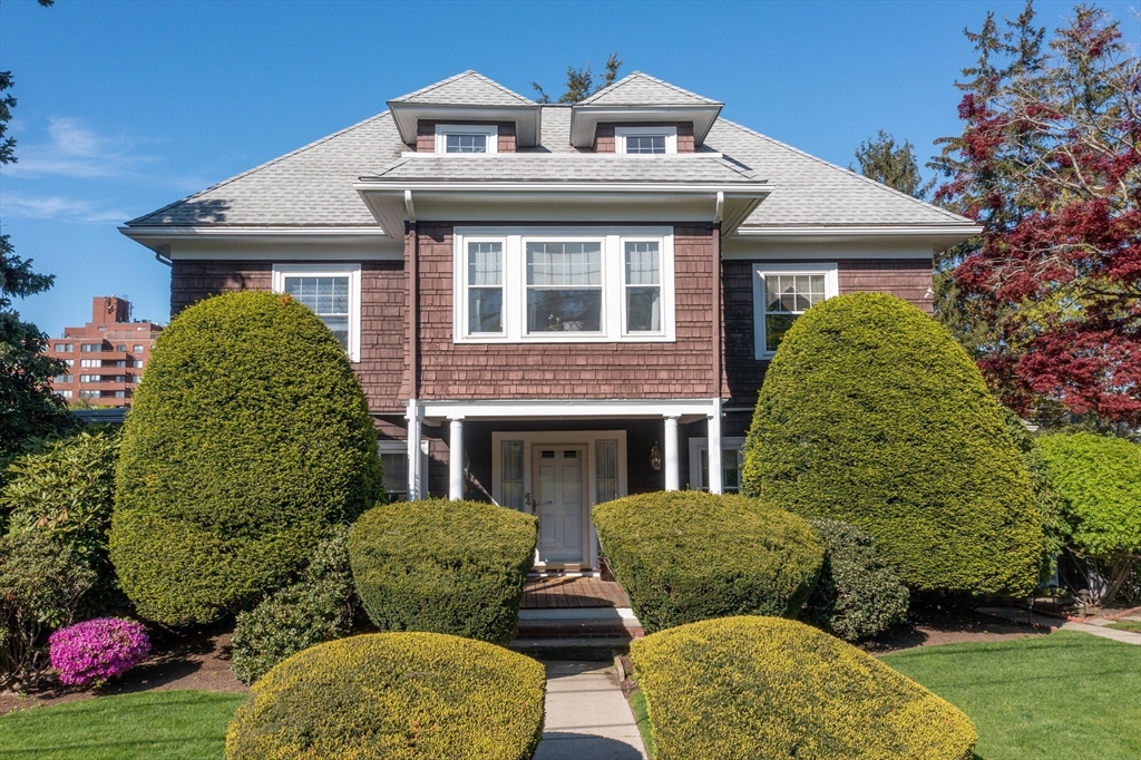 front view of a house with a garden