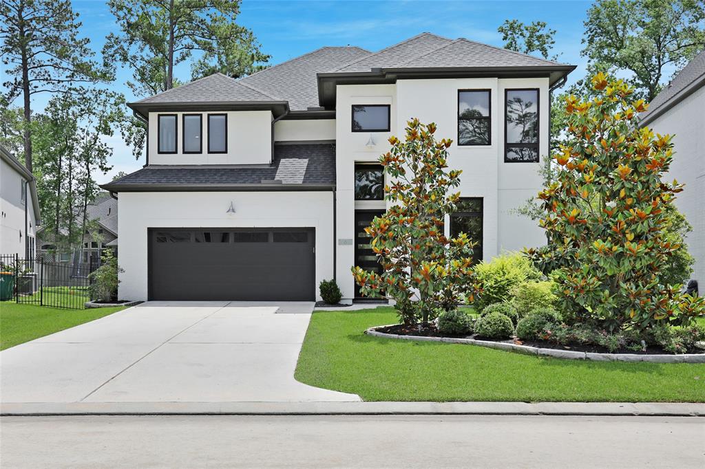 a front view of a house with a garden and plants