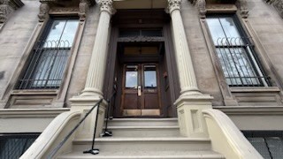 a view of staircase with white walls and railing