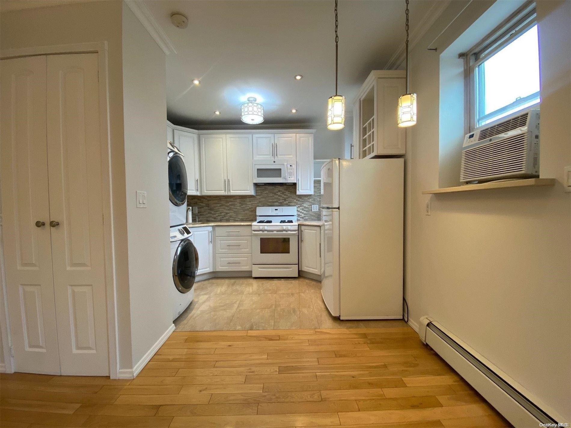 a kitchen with a refrigerator a stove top oven and cabinets