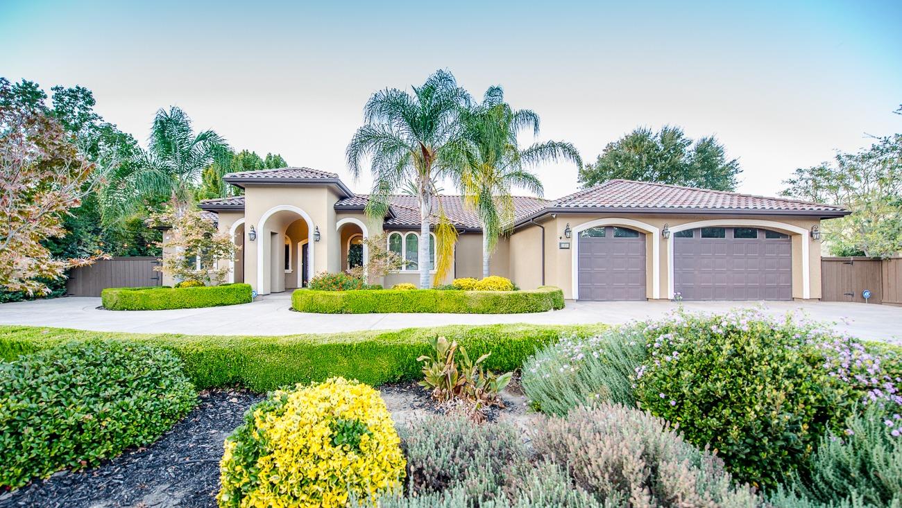 a house with a big yard and large trees