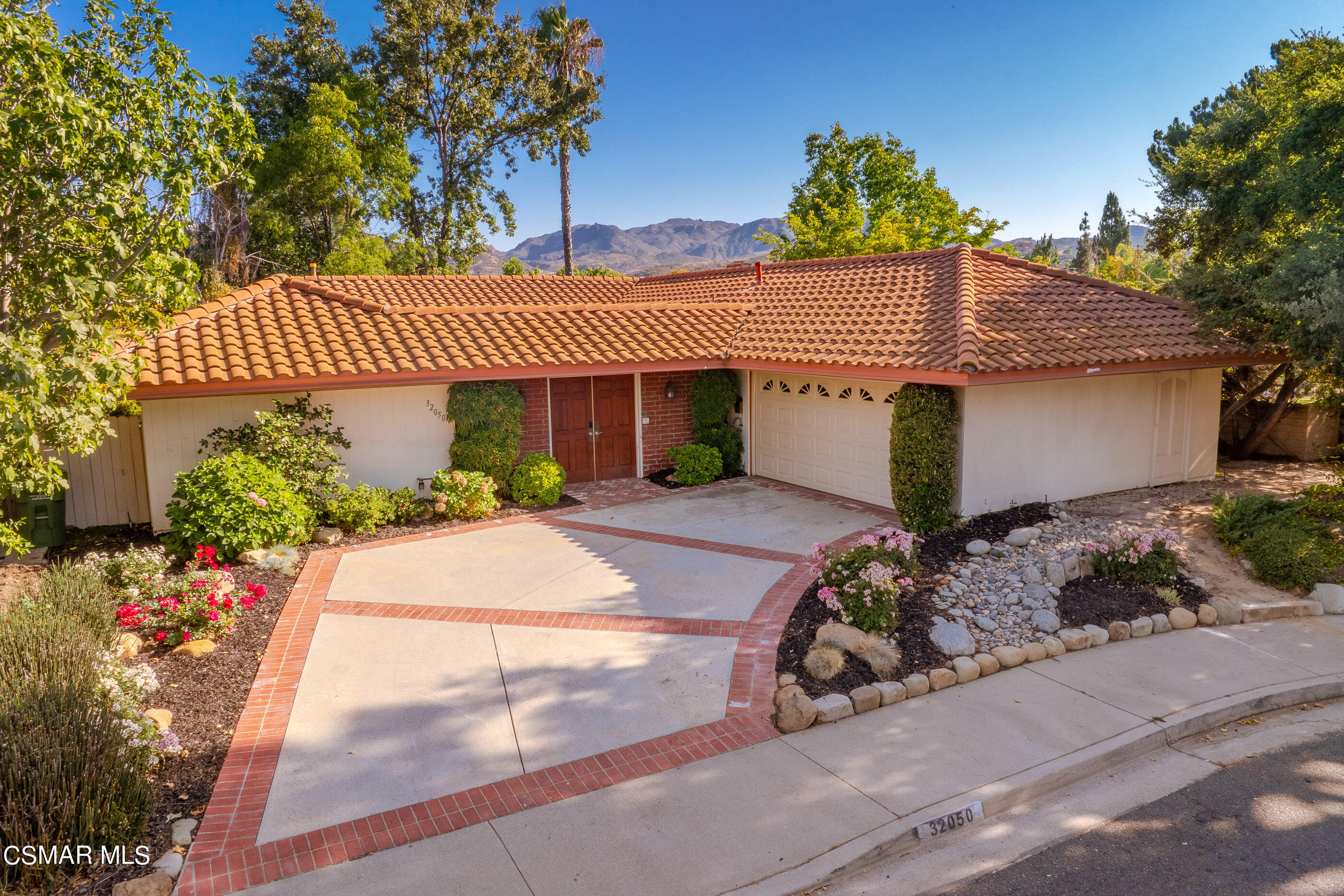 a front view of a house with garden