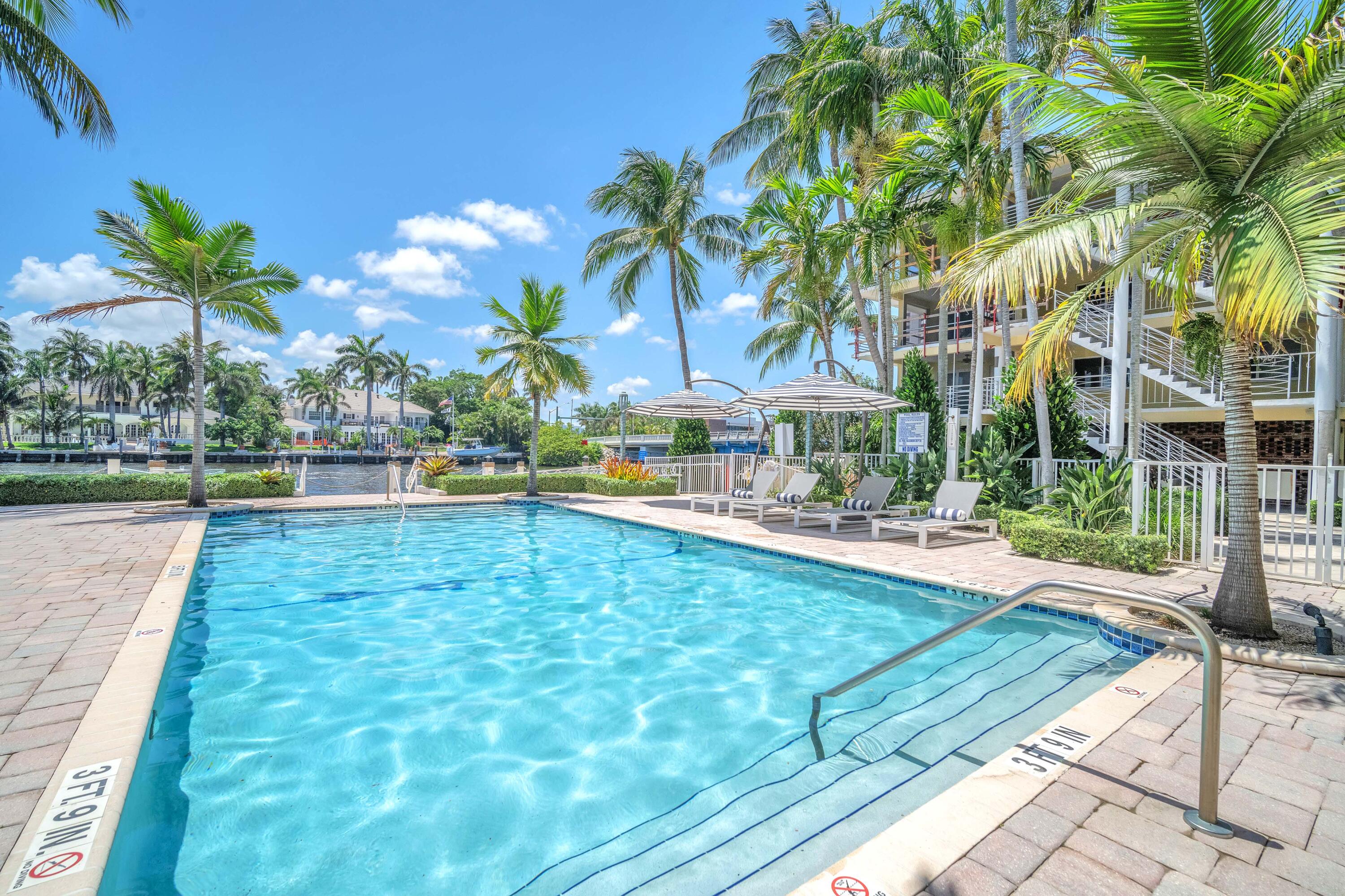 a view of yard with swimming pool and sitting area