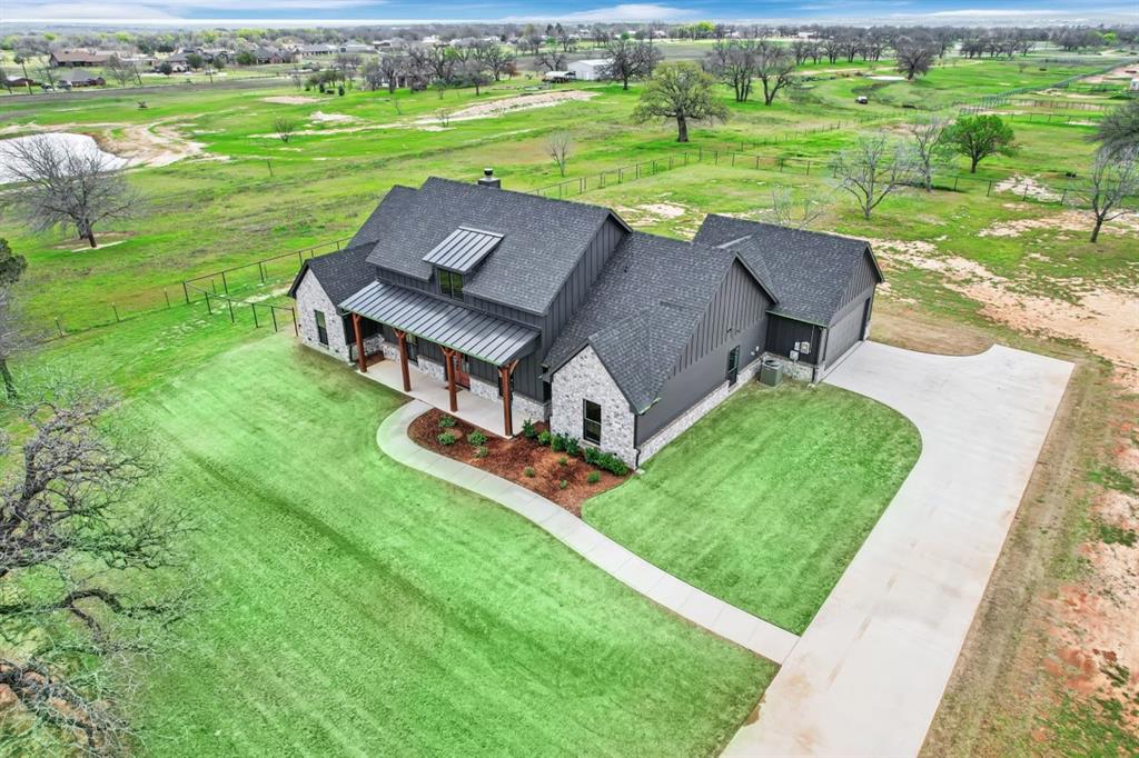 an aerial view of a house with a yard table and chairs