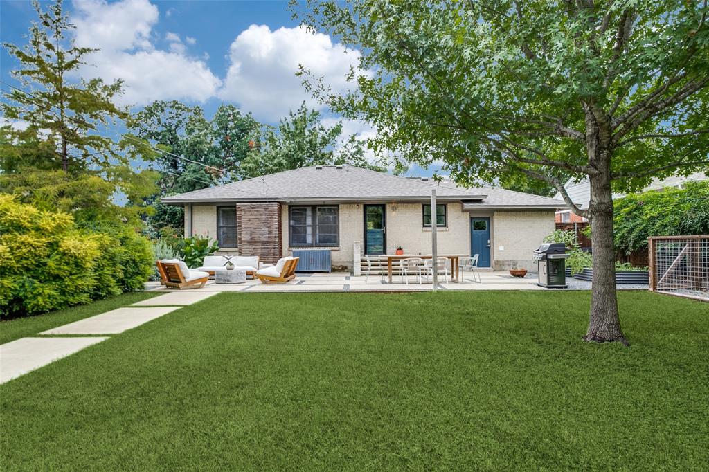 a front view of a house with yard patio and swimming pool