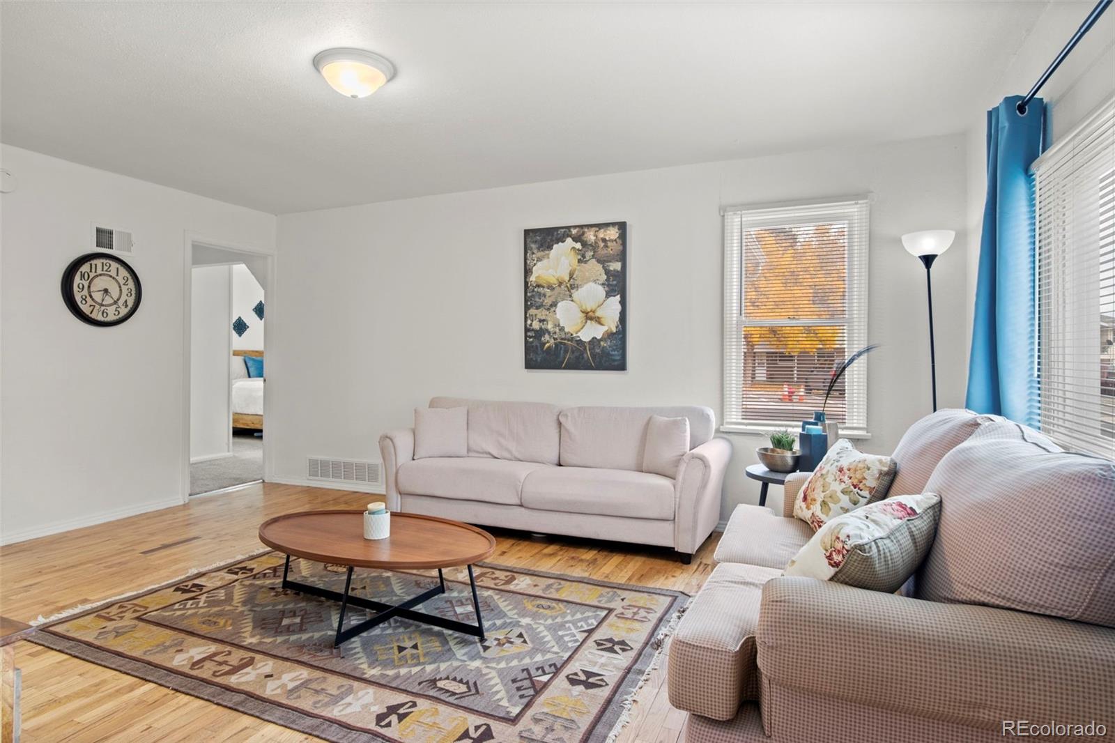 a living room with furniture a rug and a window