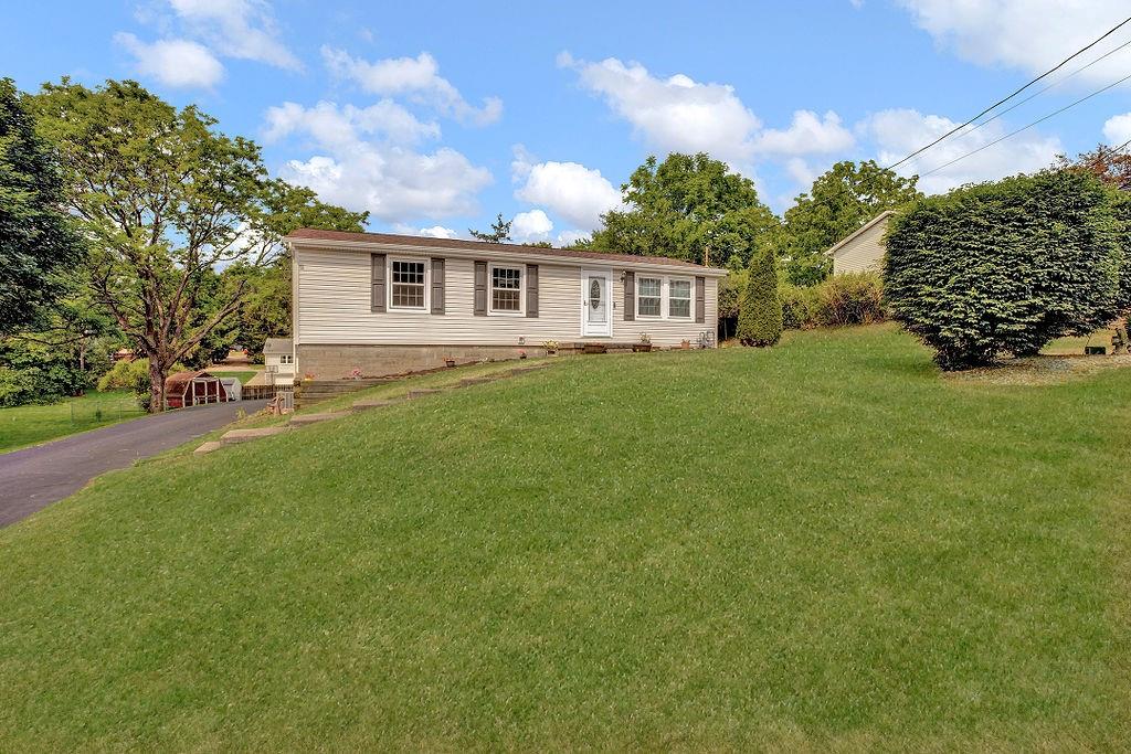 a front view of a house with a garden