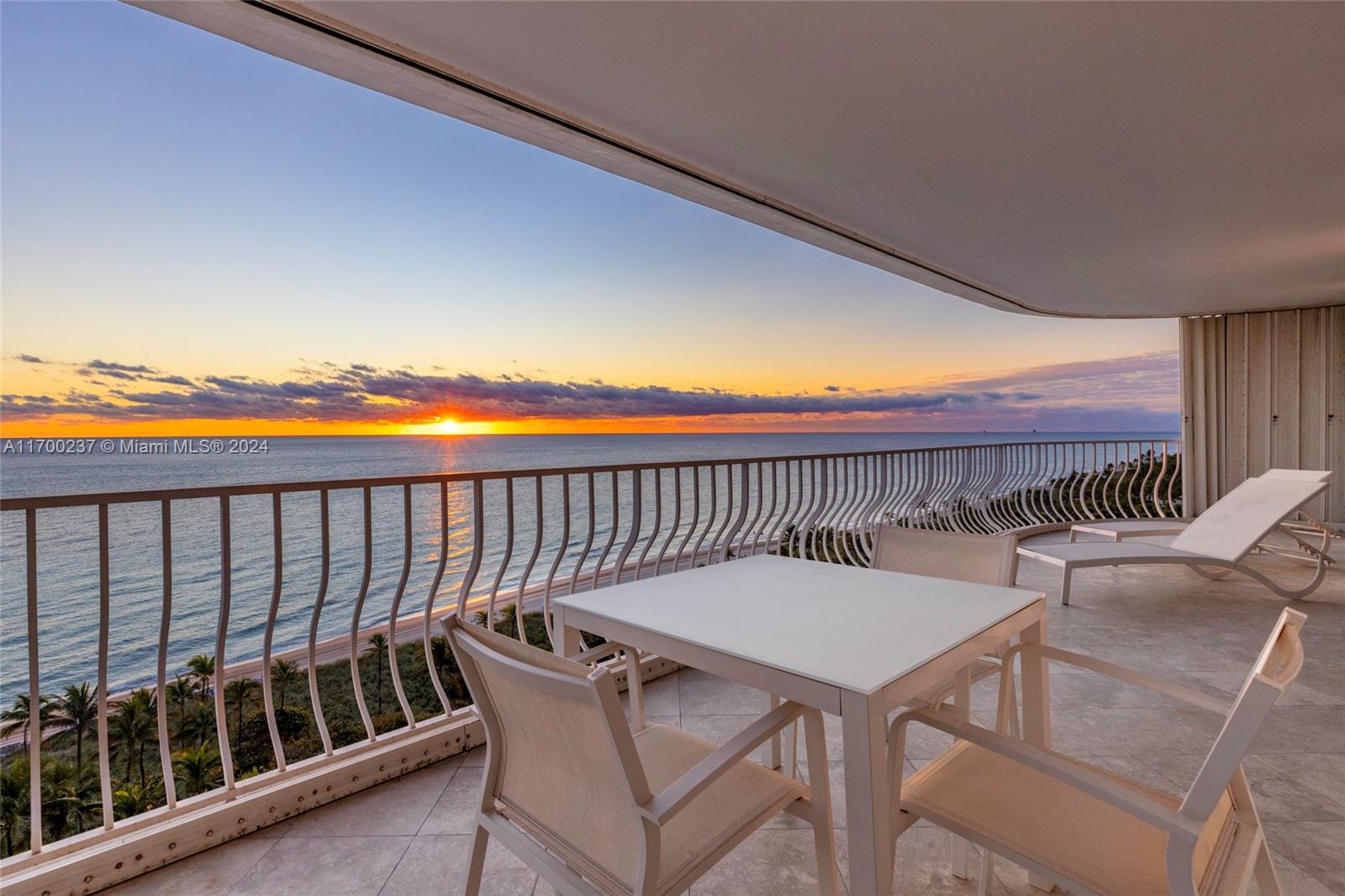 a balcony with a table and chairs