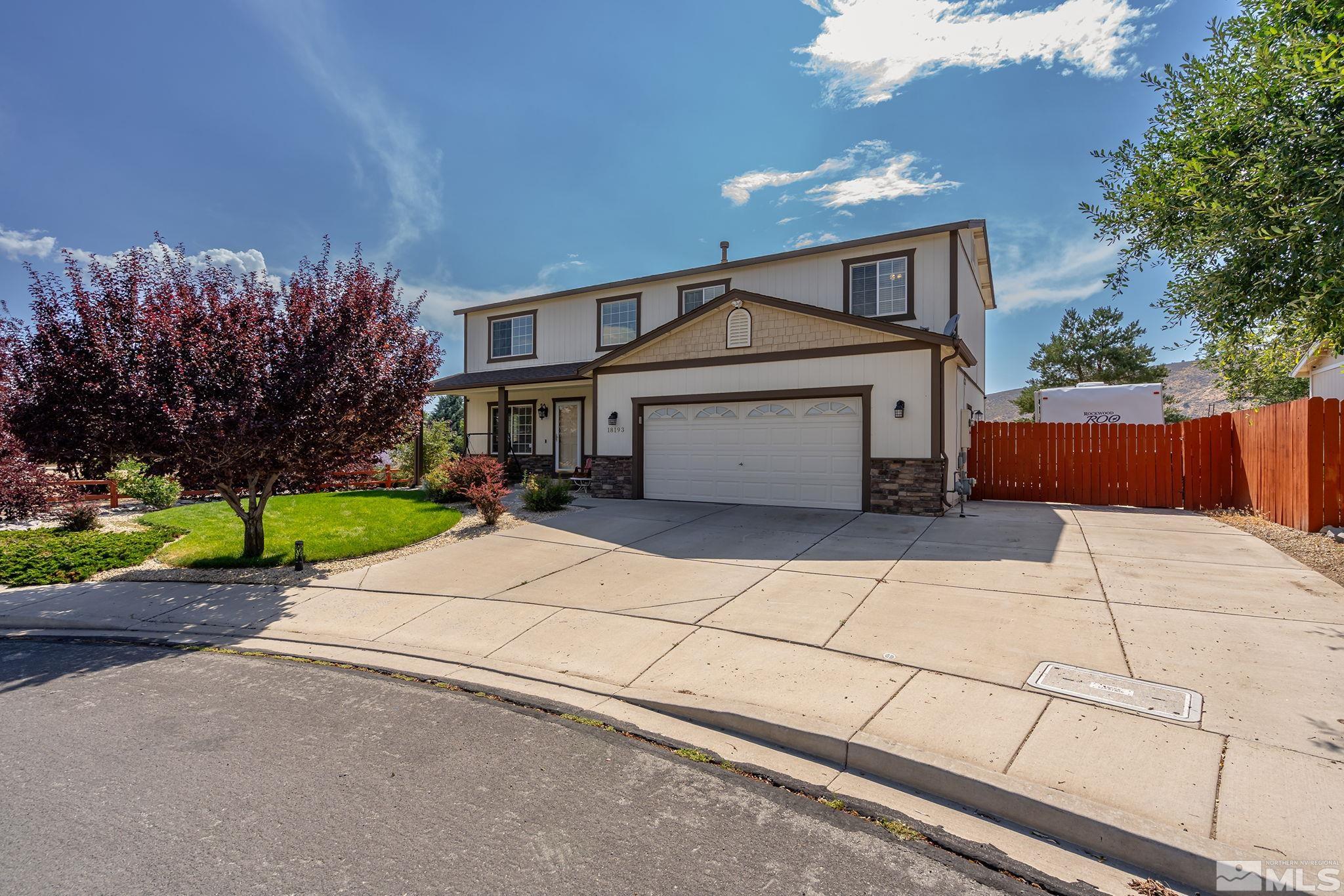 a front view of a house with a yard and a garage