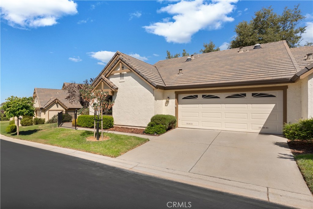 a aerial view of a house with a yard and garage