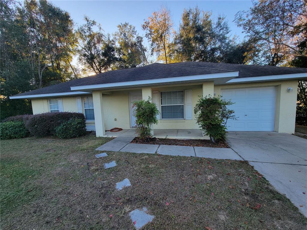 a front view of house with yard and trees