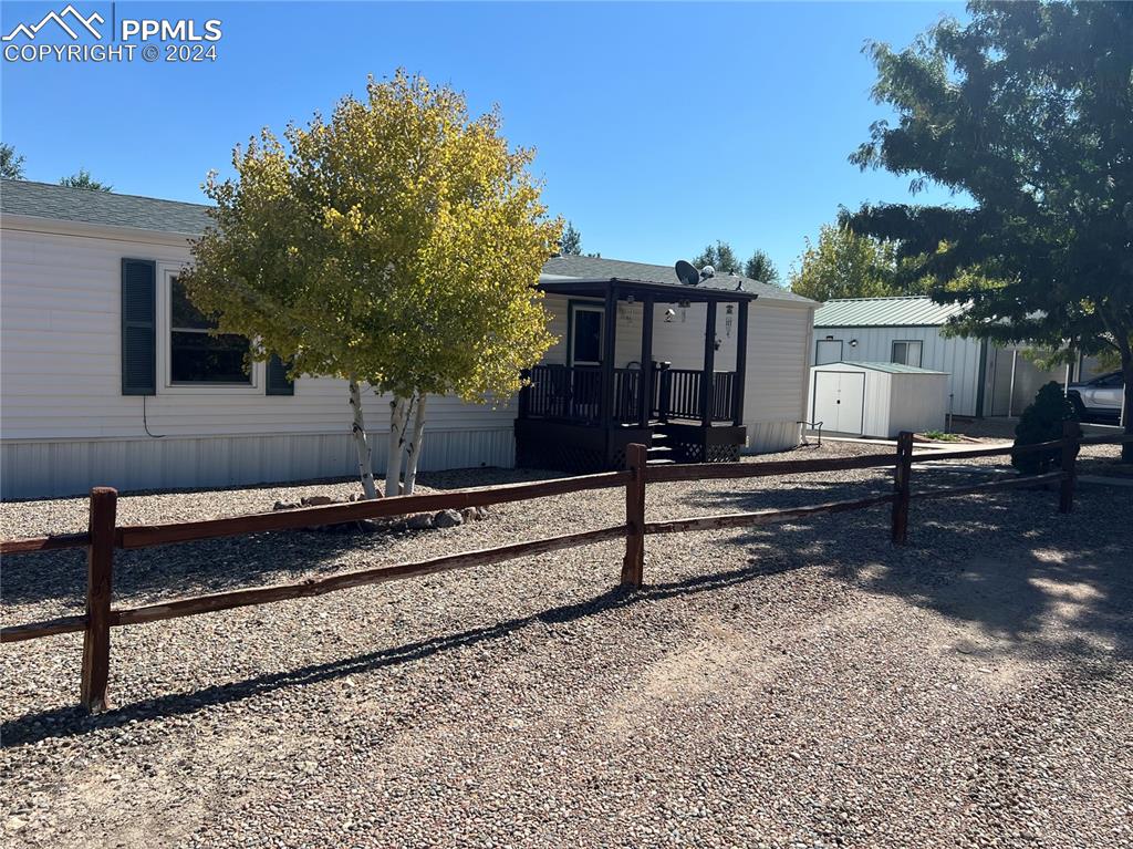 a view of a backyard with a wooden fence