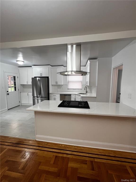 a kitchen with a stove a microwave and wooden floor