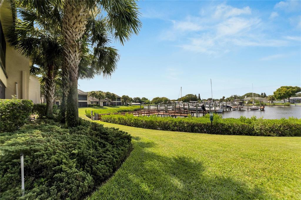 a view of a lake with a houses yard and green space