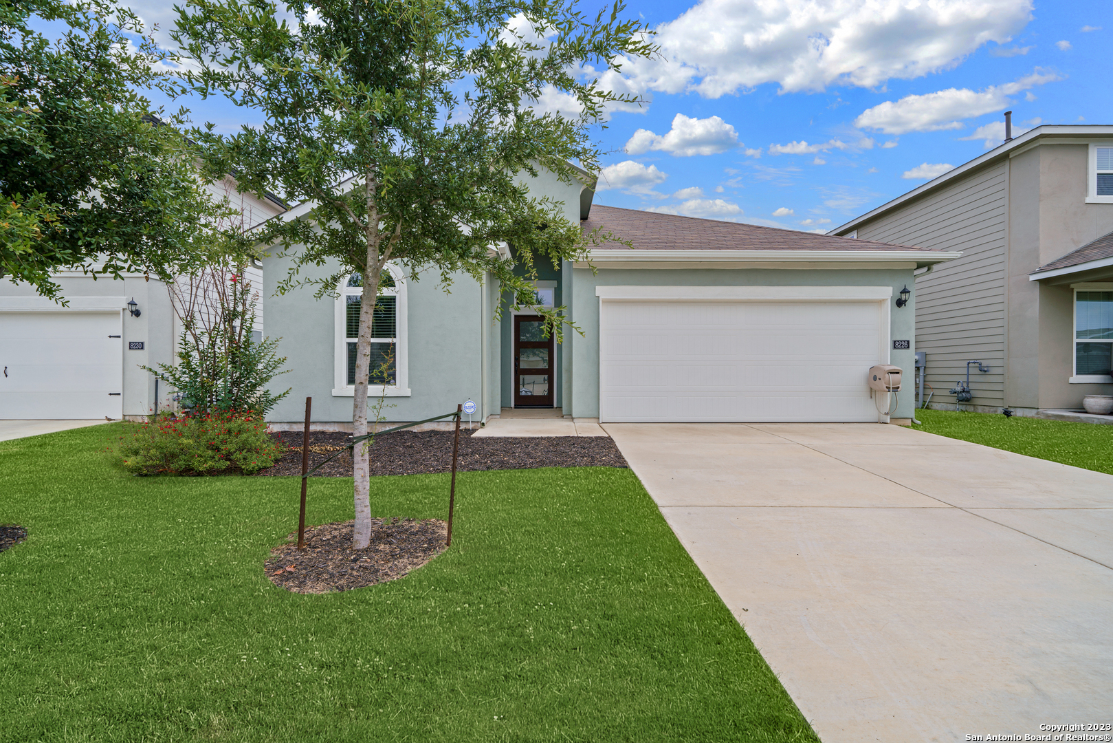 a front view of house with yard and green space