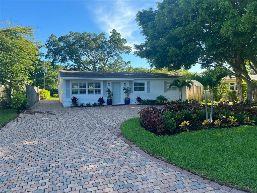 a view of a house with a backyard and a patio