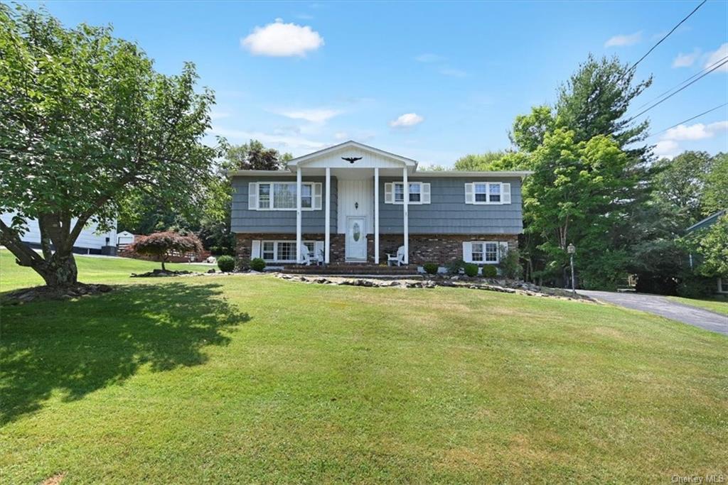 Bi-level home featuring a front lawn