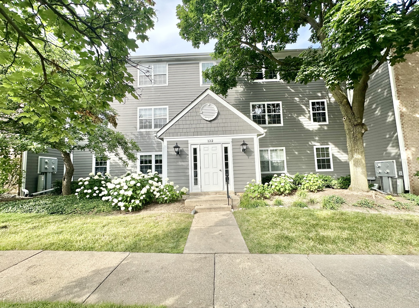 a front view of a house with garden