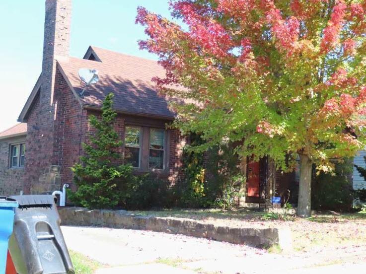 a view of a house with a tree