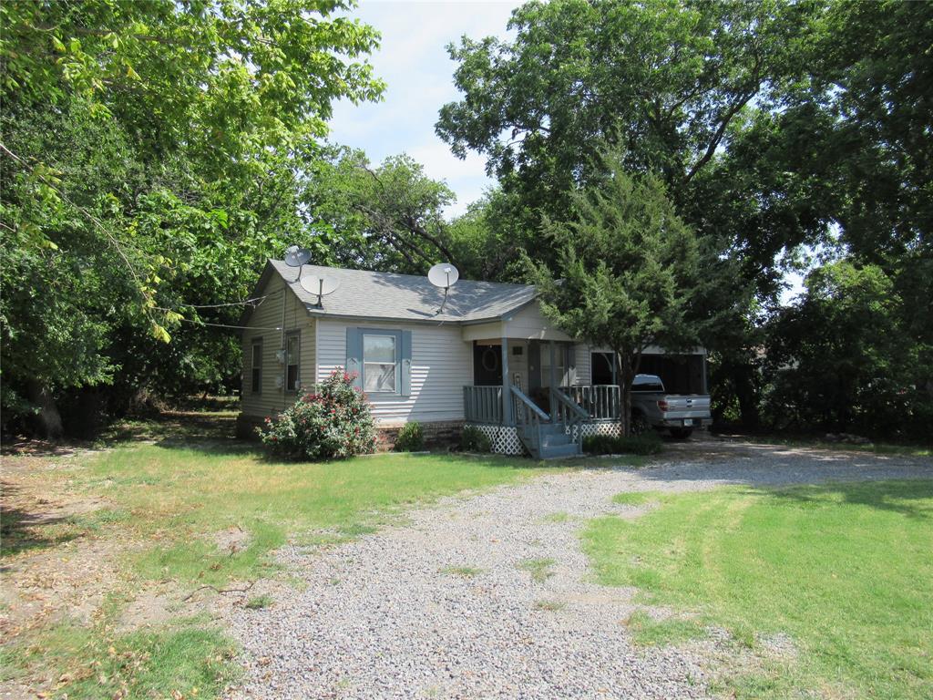 a view of a house with a yard and sitting area