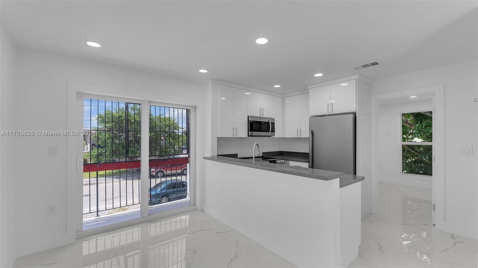 a kitchen with stainless steel appliances a refrigerator and a stove top oven