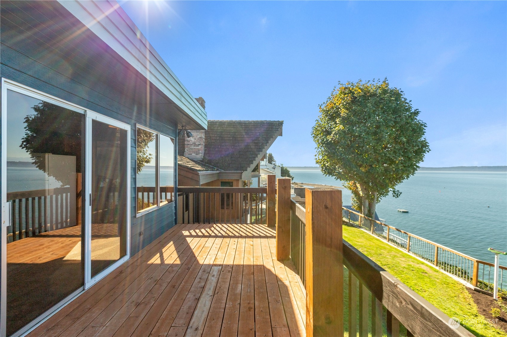 a view of balcony with a large window and wooden floor