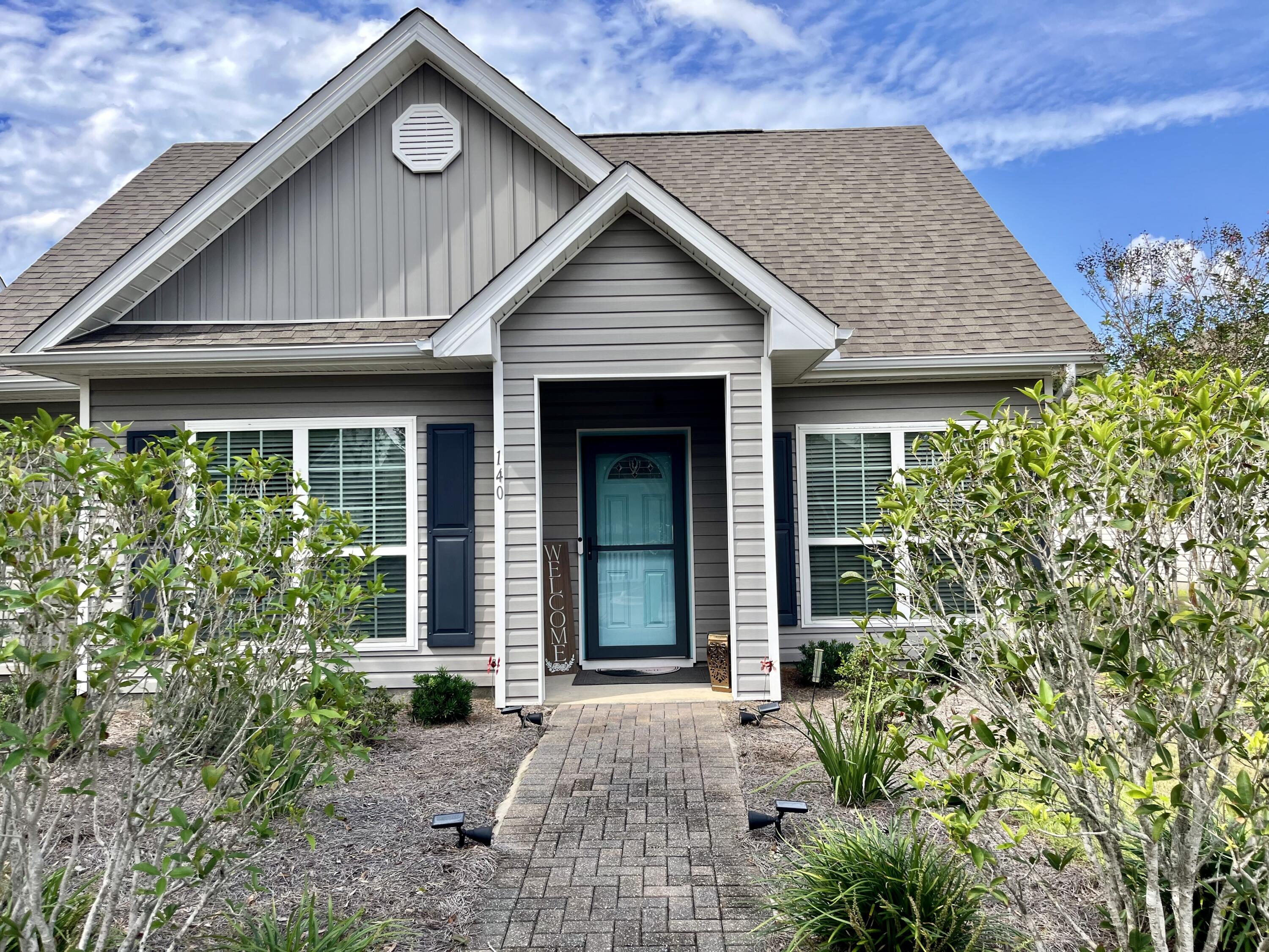 a front view of a house with garden