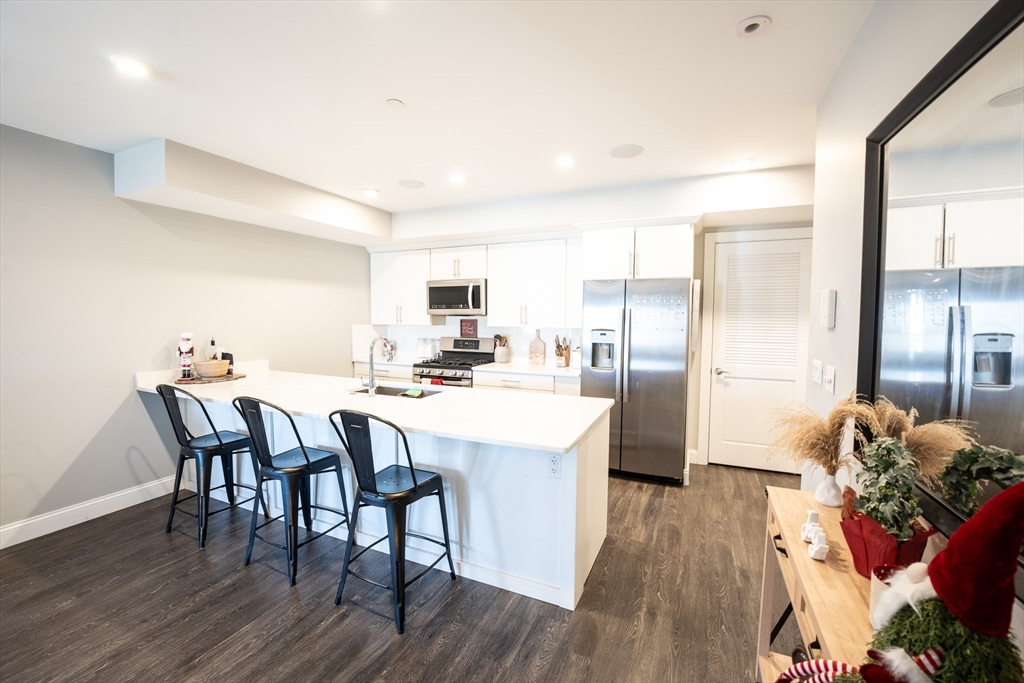 a kitchen with a table chairs refrigerator and cabinets