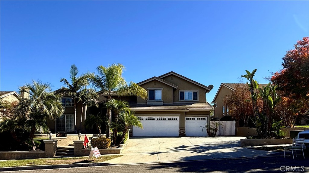 a view of a house with a yard and tree s