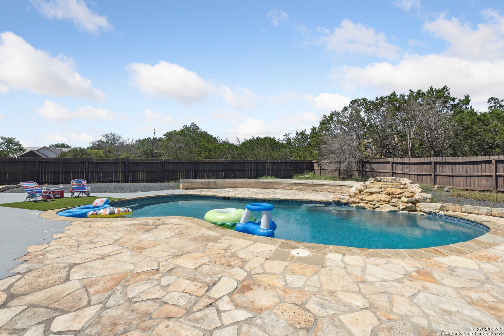 a view of swimming pool with seating space