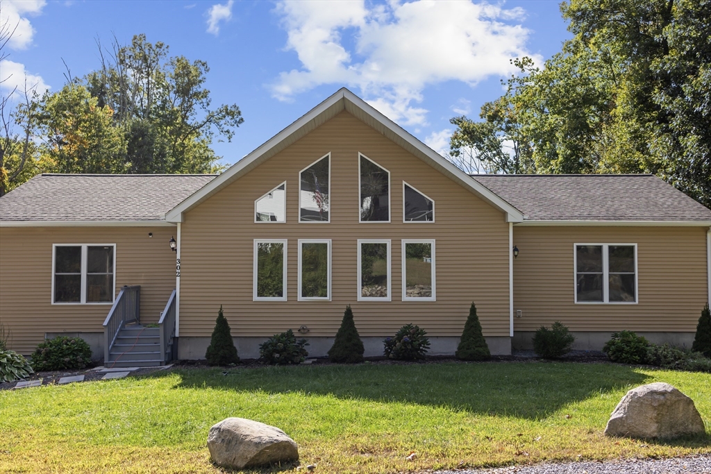 a front view of a house with a yard