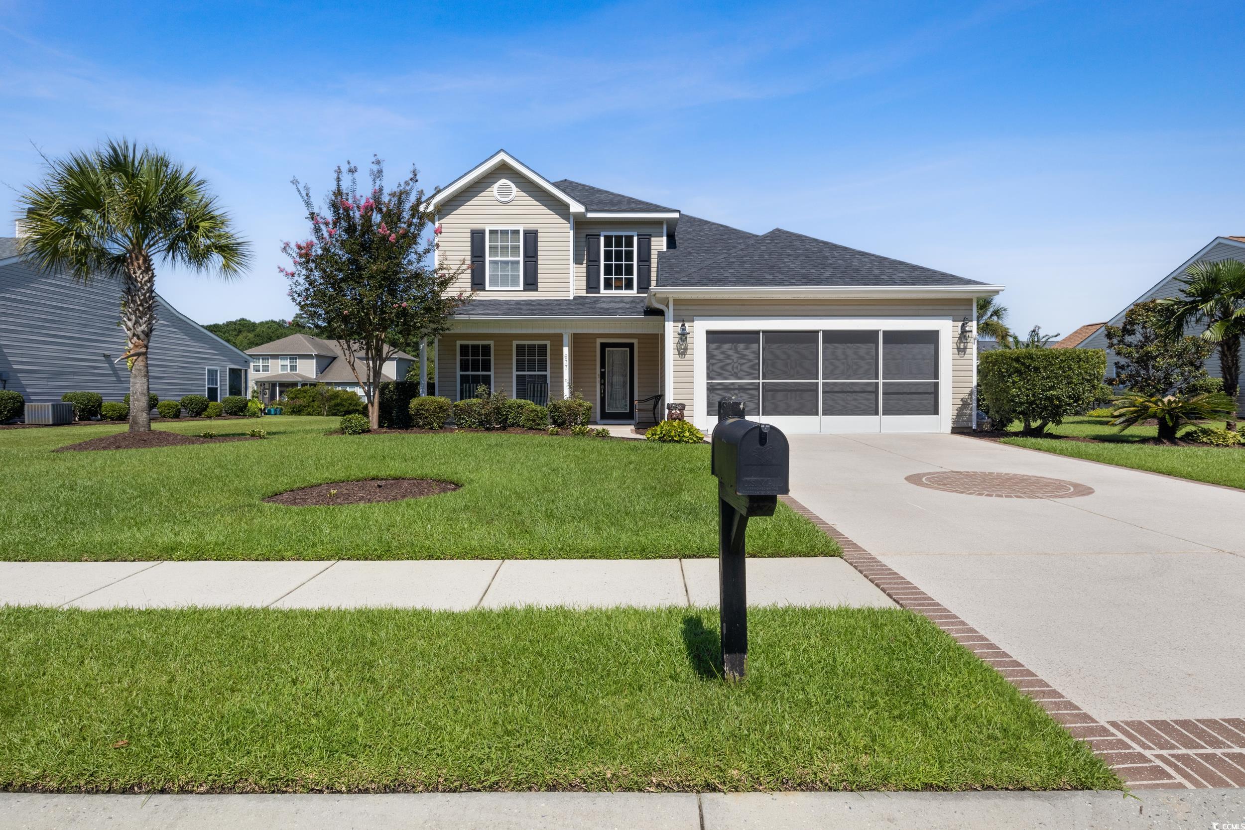 View of front of house with a garage and a front l