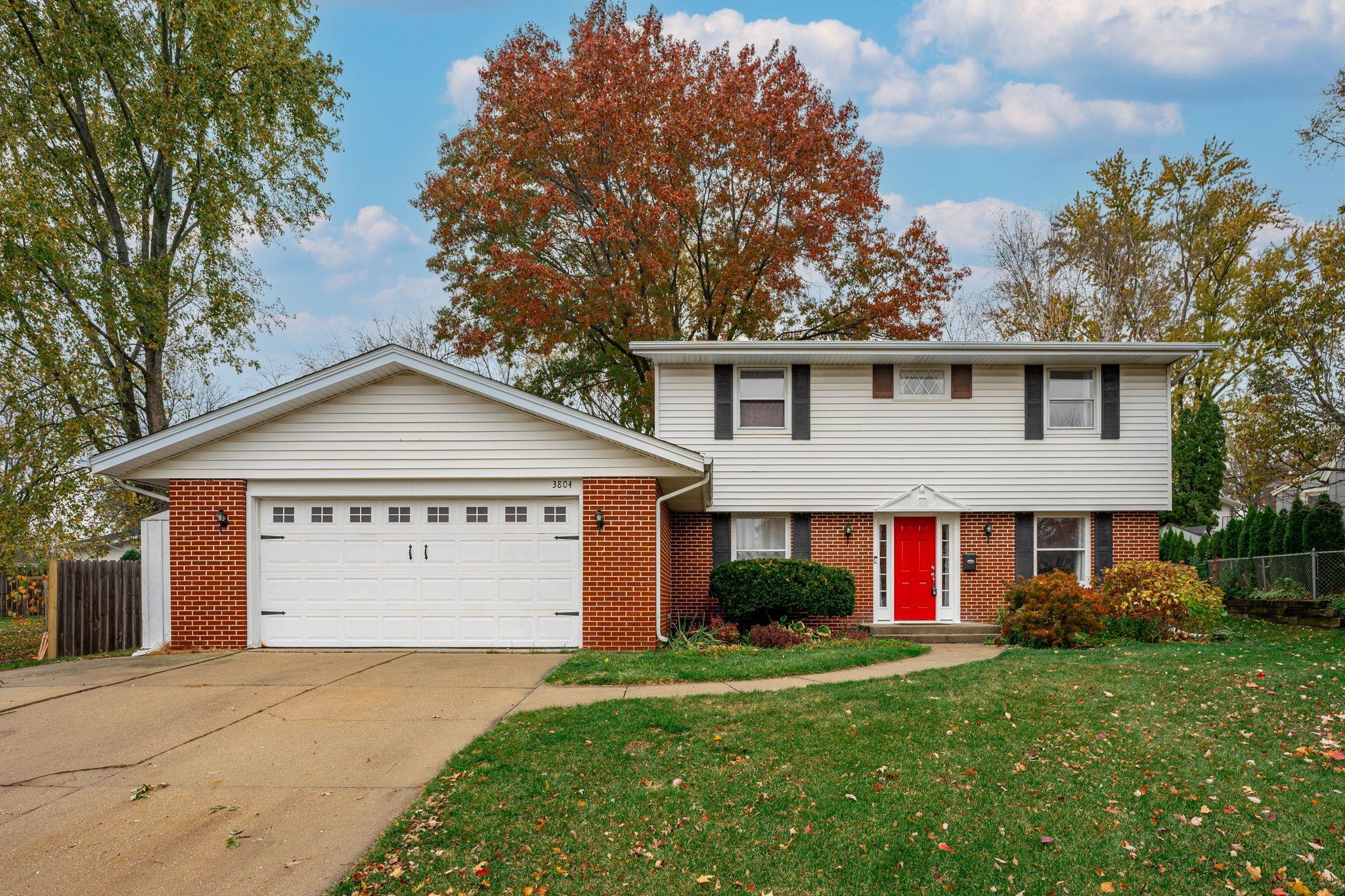 a view of front of house with a yard and garage