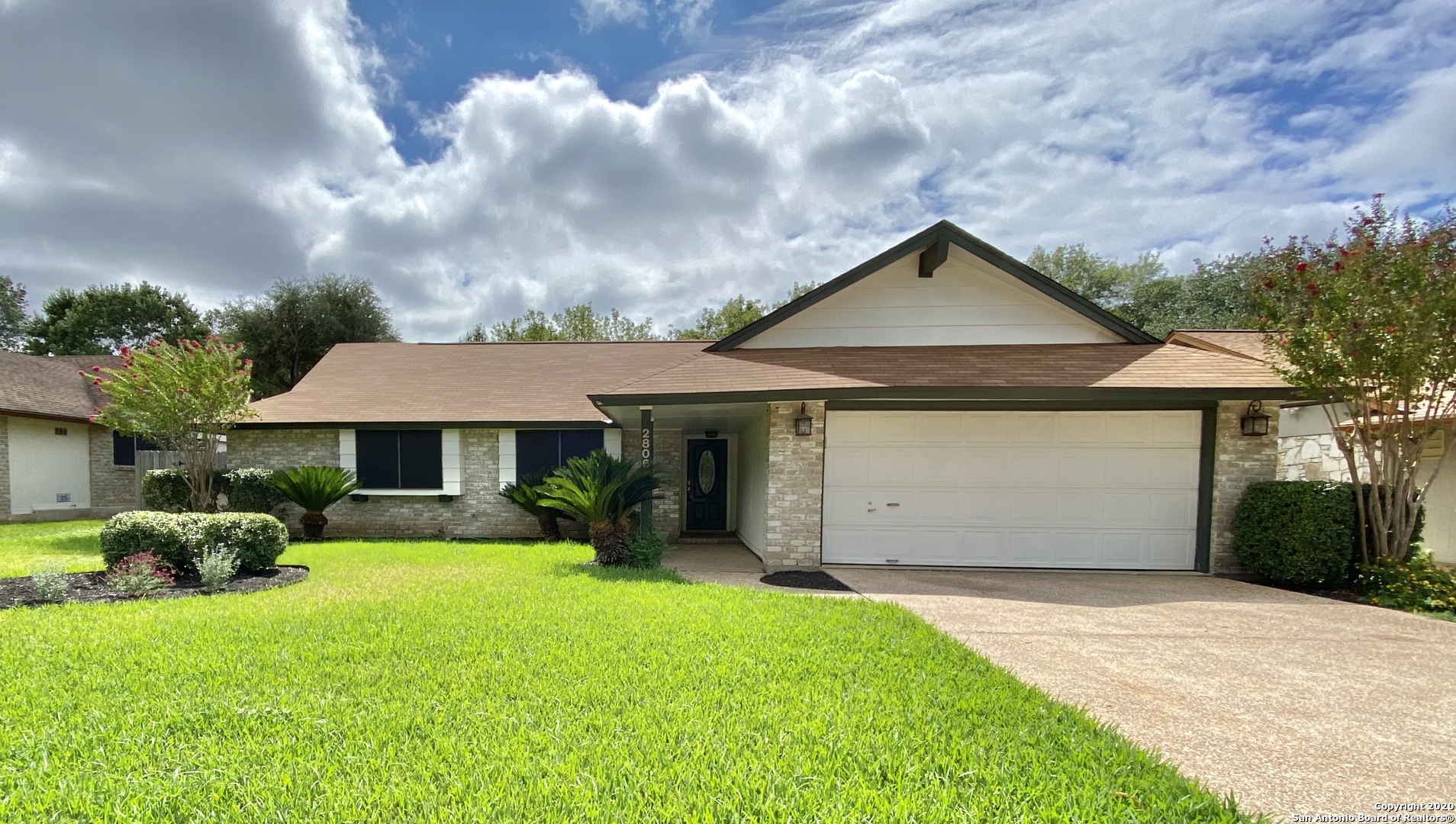 a front view of house with yard and green space