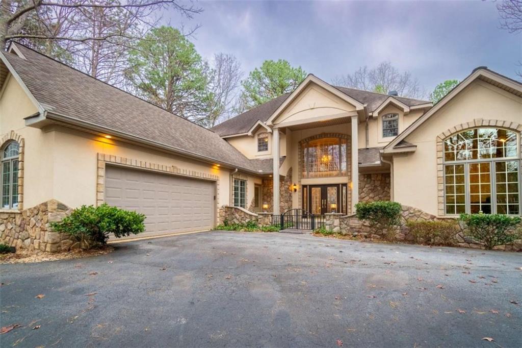 a front view of a house with a yard and garage