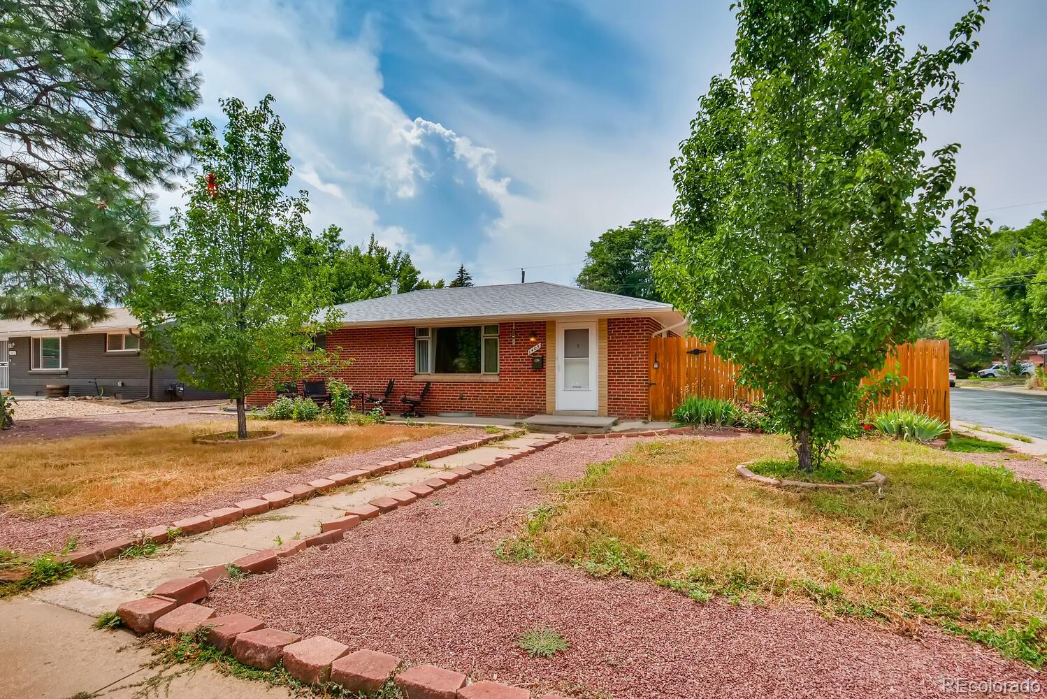 a front view of house with yard and trees