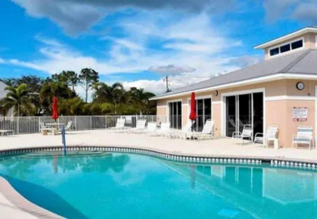 a swimming pool with outdoor seating and yard