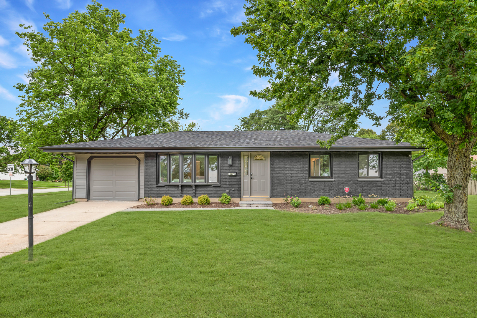 a front view of house with yard and outdoor seating