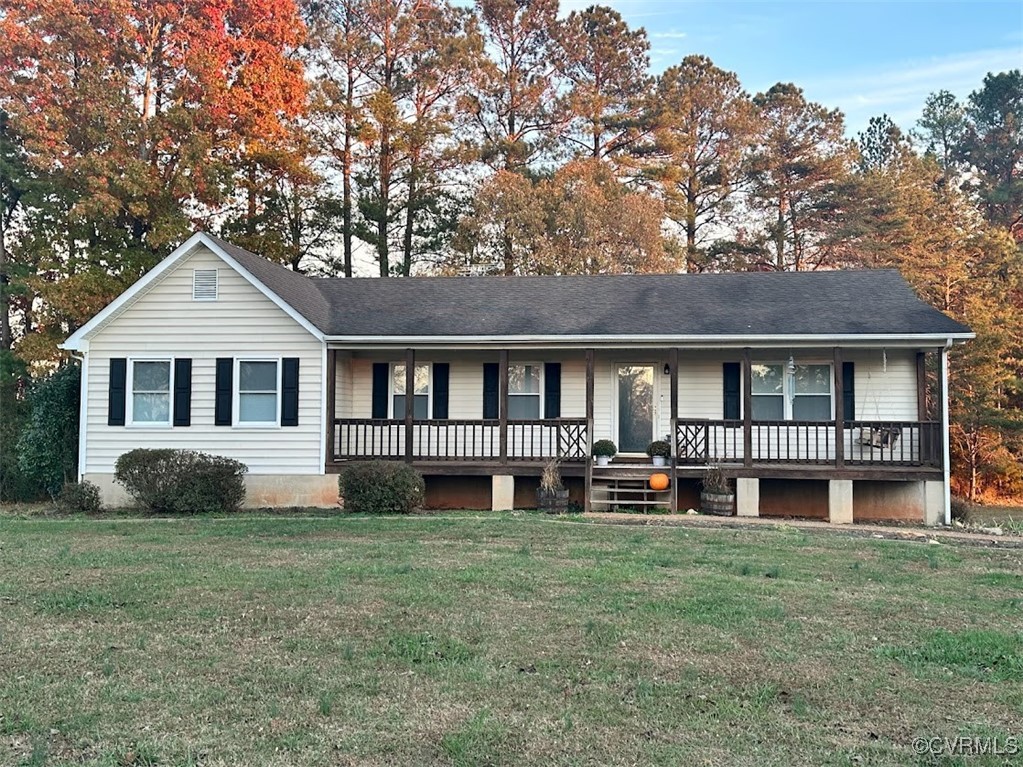 a front view of a house with yard porch and sitting area