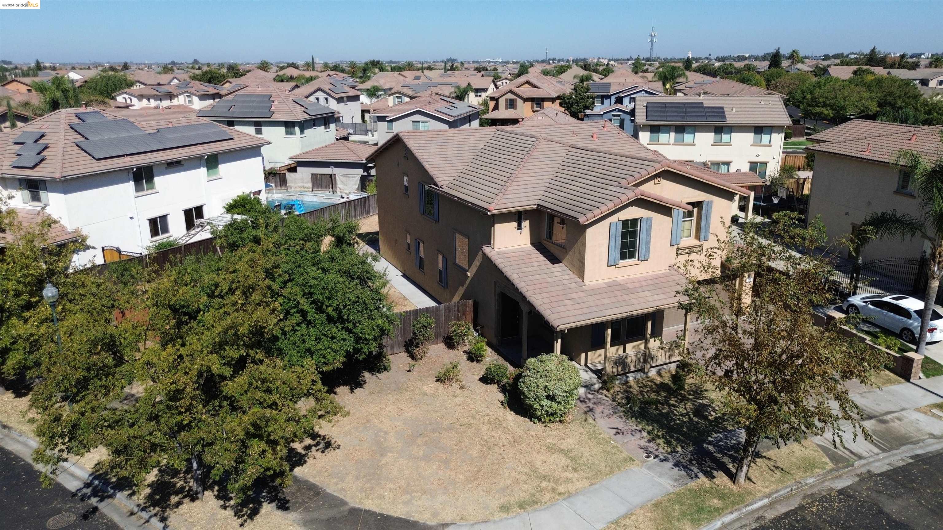 an aerial view of a house with a yard