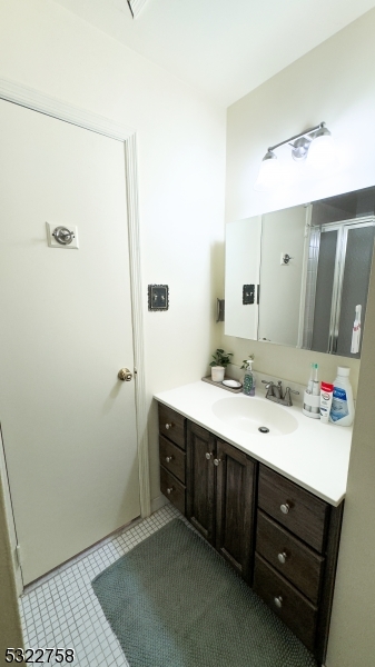 a spacious bathroom with a double vanity sink a mirror and a