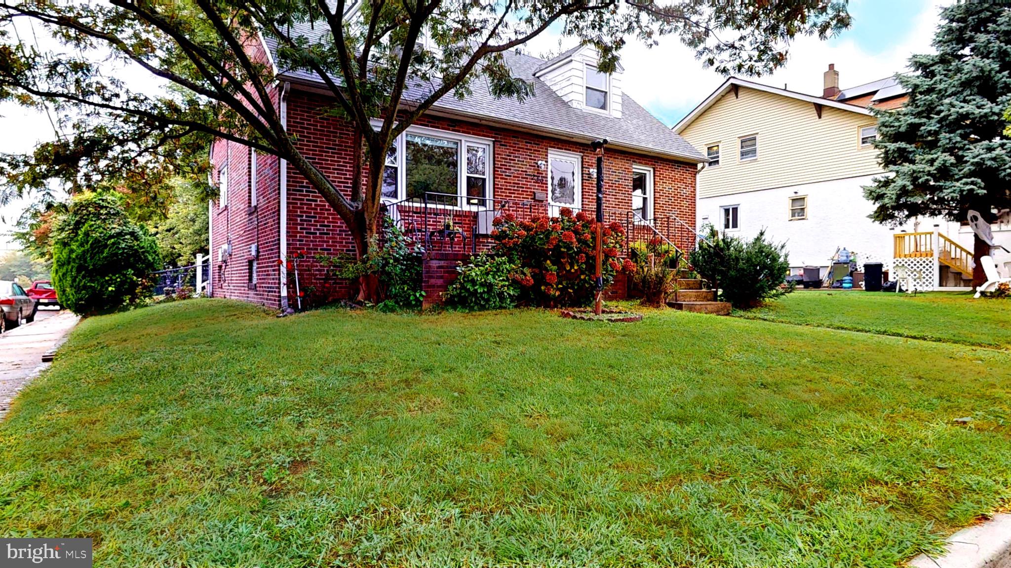 a front view of house with yard and green space