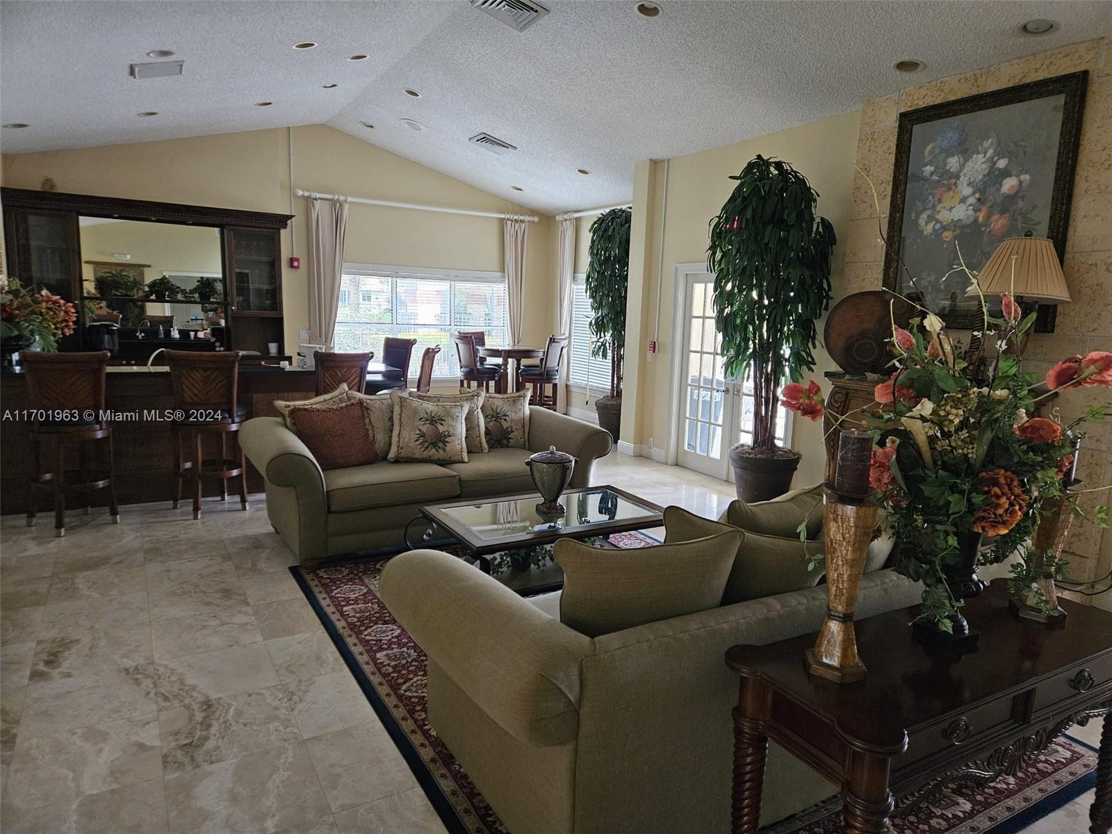 a living room with furniture potted plant and a fireplace