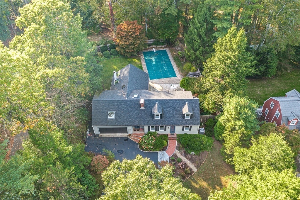 an aerial view of a house with yard