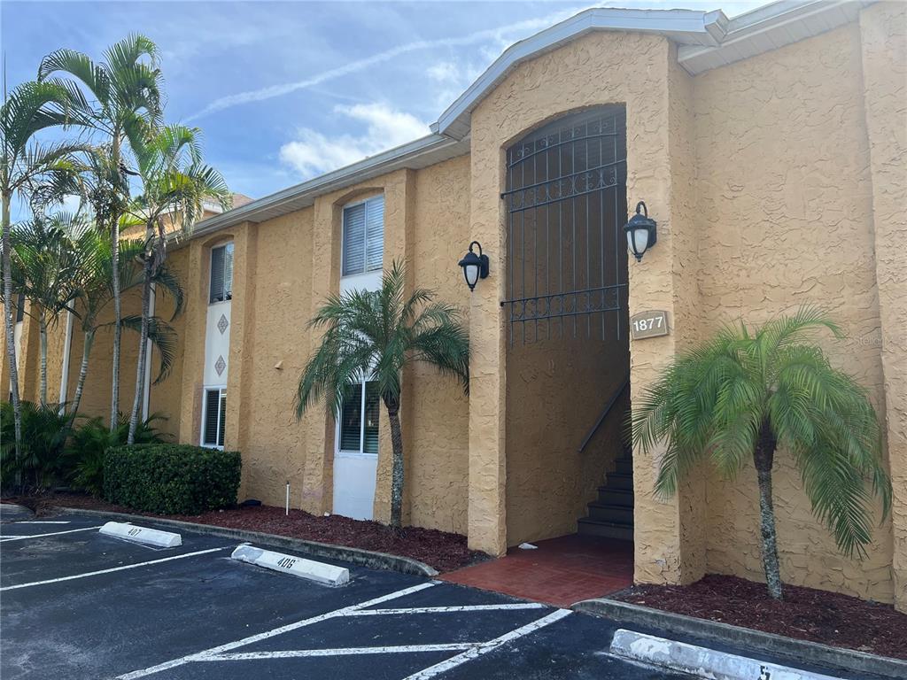 a palm tree sitting in front of a house