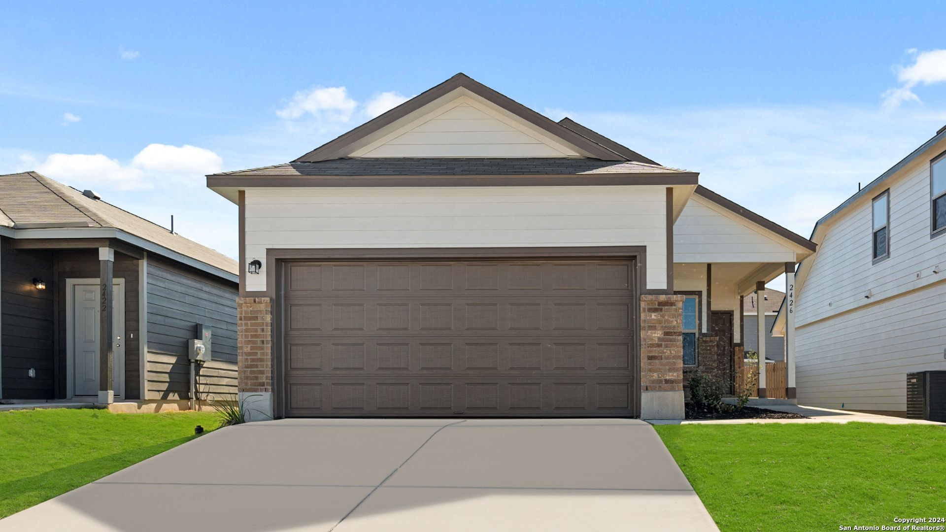 a front view of a house with a yard