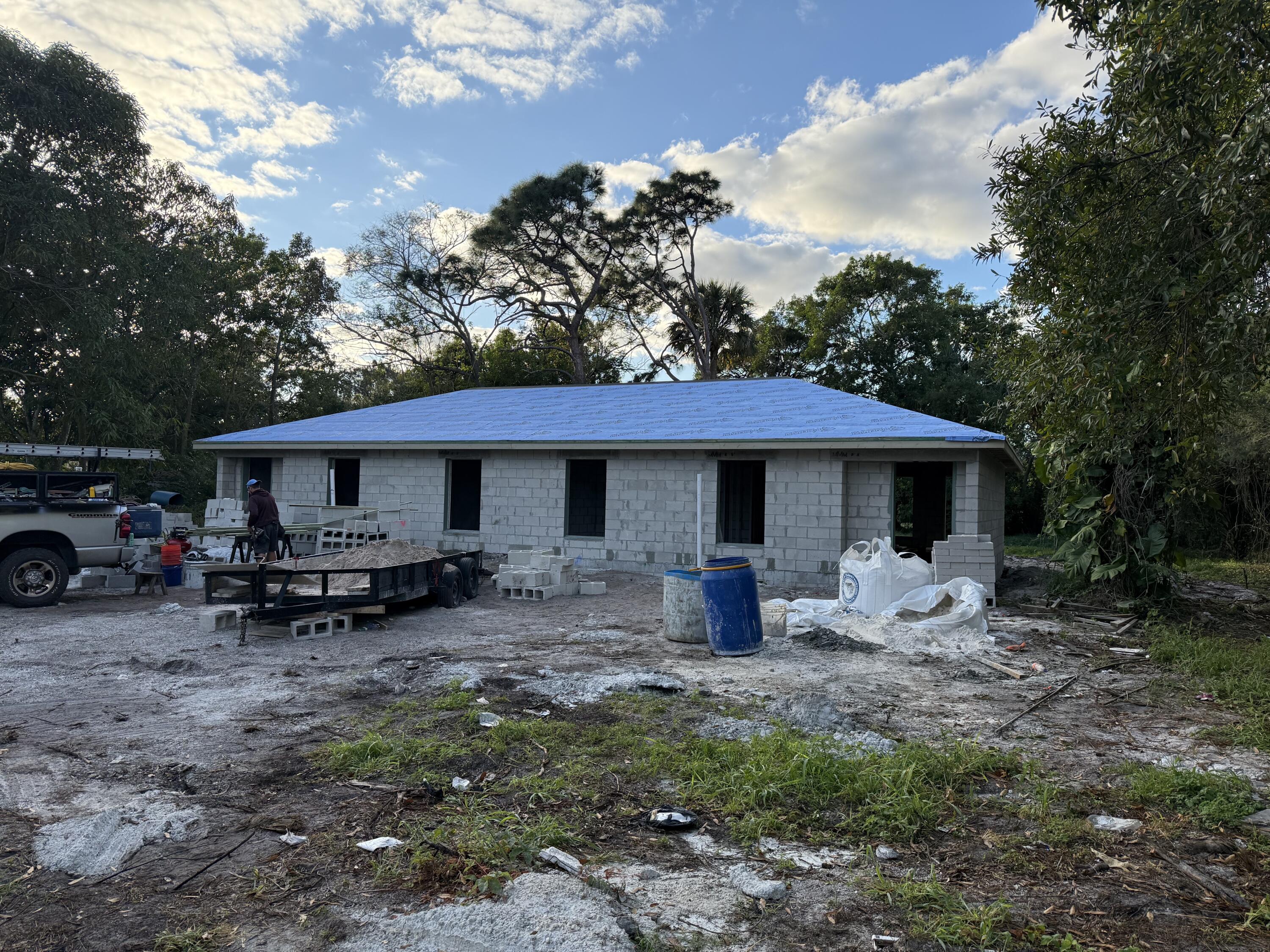 a view of a house with a sink and a chair under an umbrella