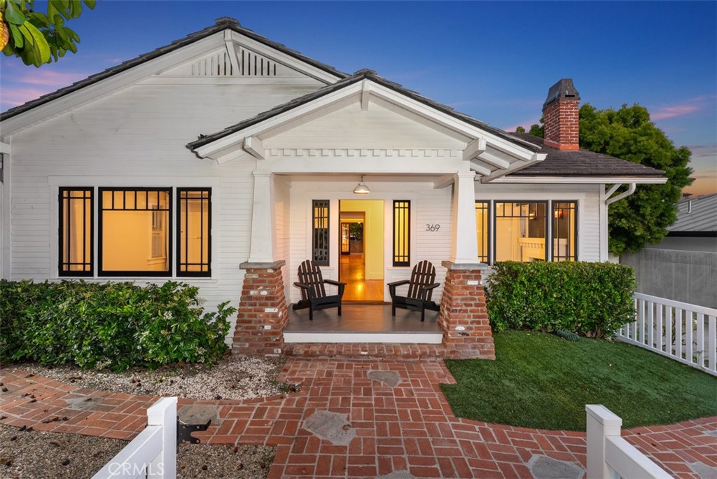 a front view of a house with outdoor seating